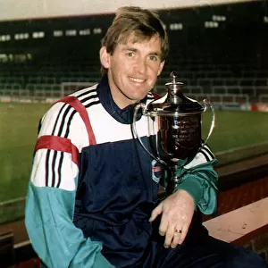 Kenny Dalglish former Footballer and Football Manager holding Man of the Decade trophy