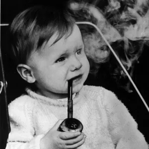 Lee Goult (17 months) smokes his cherrywood pipe, his father Allan Goult says he was