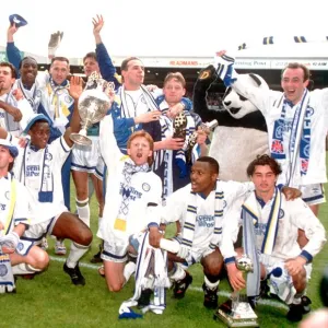 Leeds United team celebrate with the league division one championship trophy