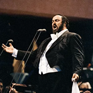 Luciano Pavarotti, the Italian operatic tenor, singing at an outdoor concert in