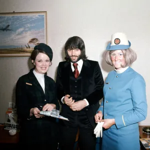 Manchester United footballer George Best with air hostesses before boarding his plane