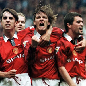 Manchester United Player David Beckham celebrates with team mates Gary Neville (left