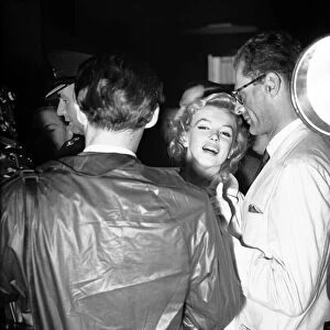 Marilyn Monroe, and husband, playwright Arthur Miller, in London to be