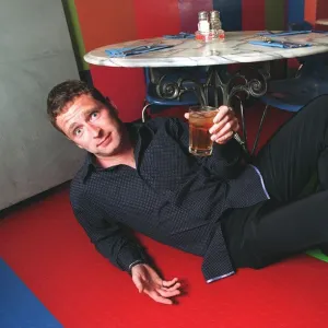 Mark Wogan son of Terry Wogan under the table with his apple juice