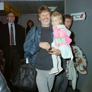 Members of The Highwaymen at Heathrow Airport. Kris Kristofferson and children