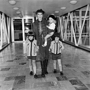 Mia Farrow at Heathrow Airport with her children Sacha, Matthew and Fletcher Previn