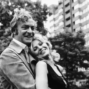 Michael Caine and Britt Ekland pose for photographers during a break in filming Get