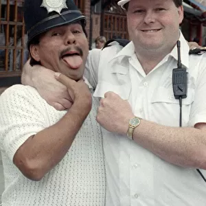 Middle Weight Boxer Roberto Duran seen here in the strong arm of the law as he hams it up