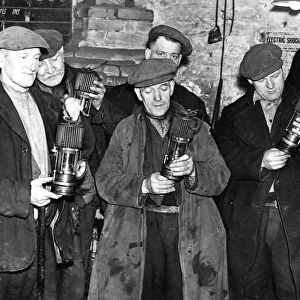 Miners drawing their lamps for the last shift which will be worked as the Dunston