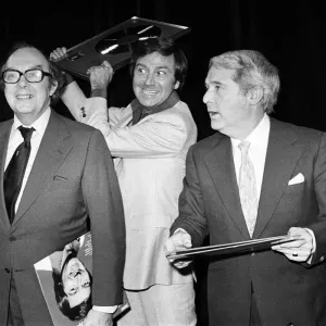 Print of Morecambe and Wise presenting Des O'Connor with a golden disc Print of Morecambe and Wise presenting Des O'Connor with a golden disc
