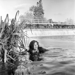 Black and white print of Cyd Hayman in the river during filming