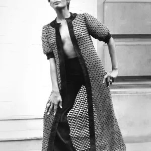 Fashion 1960s Print: A woman models a long coat and matching suede pants