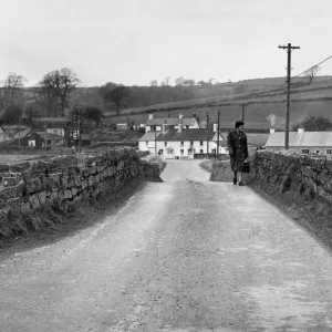 A woman crossing the bridge in Llangendeirne, Carmarthenshire Print 1964 A woman crossing the bridge in Llangendeirne, Carmarthenshire Print 1964