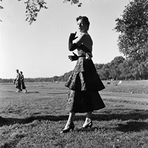 A model wearing Norman Hartnell autumn collection. Hyde Park, London. 1st September 1953
