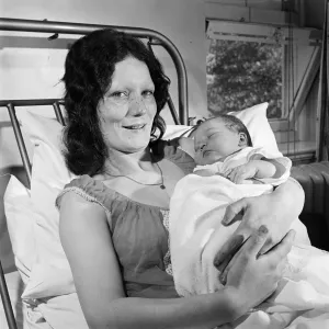 A mother holding a baby at Carter Bequest hospital. Circa 1973