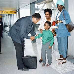 Muhammad Ali at Heathrow Airport shaking a young boys hand. 15th October 1989