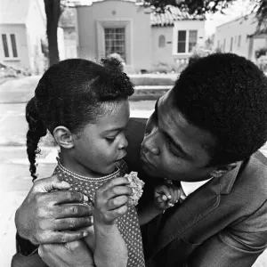 Muhammad Ali hugs a young fan. 31st August 1967