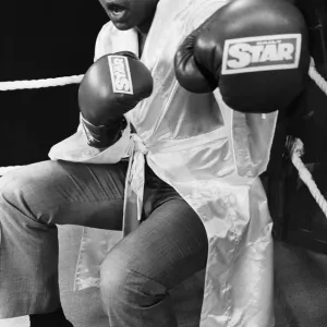 Muhammad Ali poses in a boxing ring in a sparring pose wearing boxing gloves with Daily