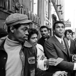 Muhammad Ali signing autographs ahead of his rematch with Joe Frazier