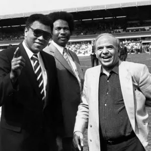 Muhammad Ali wave to the St Andrews crowd watched by councillor James Hunte