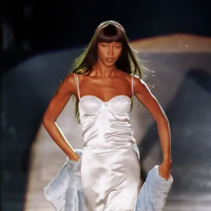 Naomi Campbell modelling a white slip dress March 1999 for designer Rocco Barocco