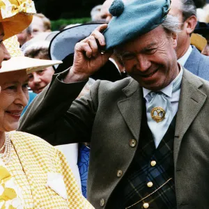 Nicholas Fairbairn MP conservative politician at garden party raising hat to the Queen