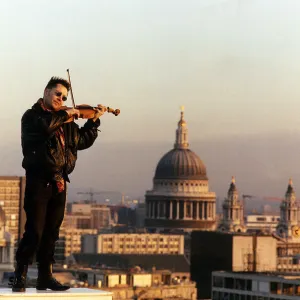 Nigel Kennedy the violinist playing his violin overlooking London