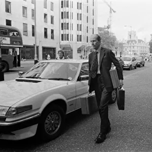 Norman Tebbit arrives with three despatch boxes at the Department of Trade, Victoria