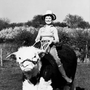 Pamela Noel is taking one of her Hereford bulls for a ride on ther farm near Reading