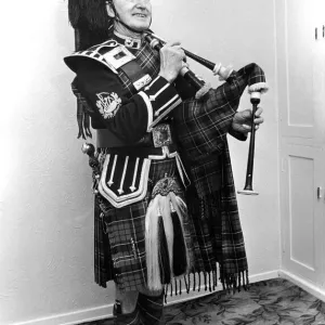 A piper smarly dressed in his uniforn and ready to play the bagpipes in March 1982