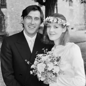 Pop star Bryan Ferry poses with his bride Lucy Helmore after thier wedding ceremony at St