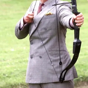 Prince Charles with bow and arrow at archery practice at clay pigeon shoot to raise money