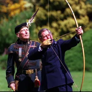 Prince Charles trys his hand at archery with the Royal Company of Archers