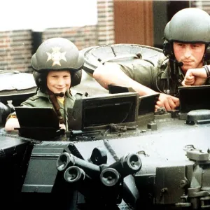 Prince Harry riding in a British Army light tank during a visit to the barracks of