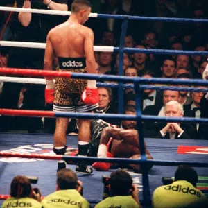 Prince Naseem Hamed looks down at Tom Boom Boom Johnson after knocking him to the canvas