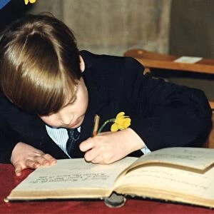 Prince William signing his name in the visitors book of Llandaff Cathedral in Cardiff