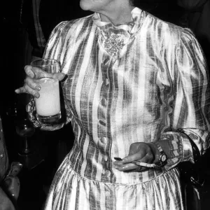 Princess Margaret smoking with cigarette holder and drinking orange at the Pye TV awards