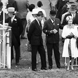 Queen Elizabeth II accompanied by the Duke of Norfolk watching the parade of Oaks runners