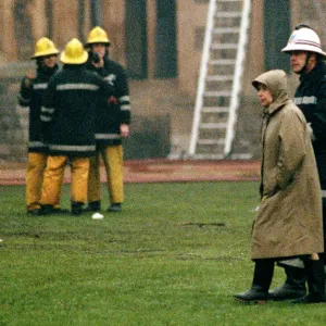 The Queen is escorted by the chief fire officer around the grounds of Windsor Castle as