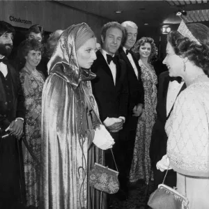 The Queen meeting Barbra Streisand watched by James Caan