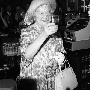 Queen Mother drinks a pint of beer in a pub in Stepney