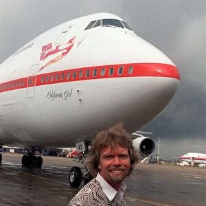 Richard Branson standing in front of one of his Virgin Airways Boeing 747 jumbo jet