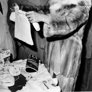 Richard Burton actor and Elizabeth Taylor who recently remarried buying a baby suit