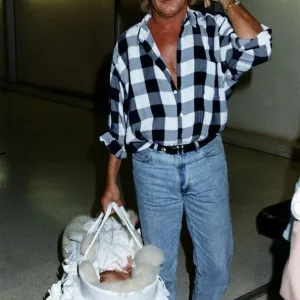 Rod Stewart Singer With baby daughter leaving Heathrow