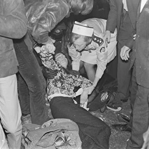 Rolling Stones. A fanlays on the ground being tended to by a St Johns Ambulance Brigade