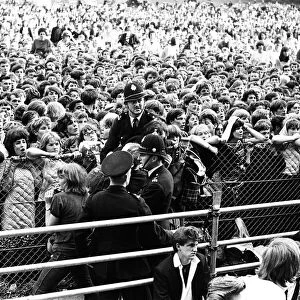 The Rolling Stones at Longleat, home of Lord Bath. Fainting girl fans are carried