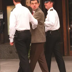 Rowan Atkinson Actor as Mr Bean filming at Harrods - being arrested by policemen