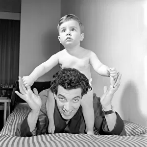 Singer Frankie Vaughan seen here playing with his son David. Circa 1957