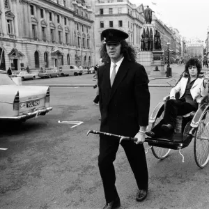 Singer Marc Bolan in a rickshaw in London. Drawing the rickshaw is Alphie O Leary