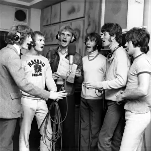 Singing along with tennis ace Ray Moore in the recording studio are Bee Gees Robin Gibb
